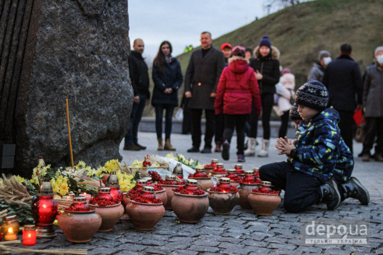 Дети на коленях у мемориала жертвам Голодомора